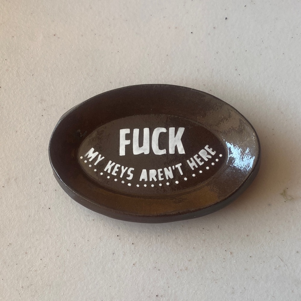 Brown Oval Key Dish with White Text
